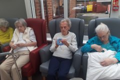 Making Pom Poms at care home in Hyde