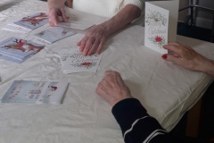 Writing Christmas cards for family and friends at Charnley House care home in Hyde