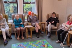 Playing giant snakes and ladders at Charnley House residential home in Hyde