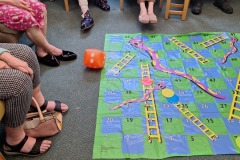 Playing giant snakes and ladders at Charnley House residential home in Hyde