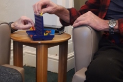 Residents playing Connect 4 at residential home in Hyde